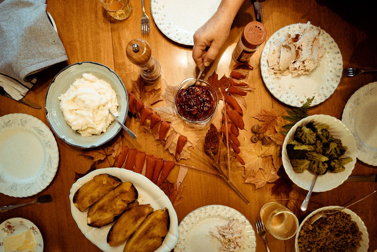 Thanksgiving meal on a table with autumn leaves